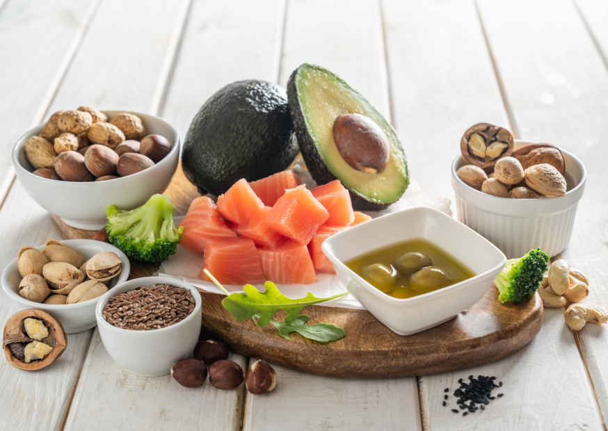 Colorful assortment of nutrient-rich foods, including eggs, spinach, nuts, and salmon, showcasing essential vitamins and minerals for promoting healthy hair growth.